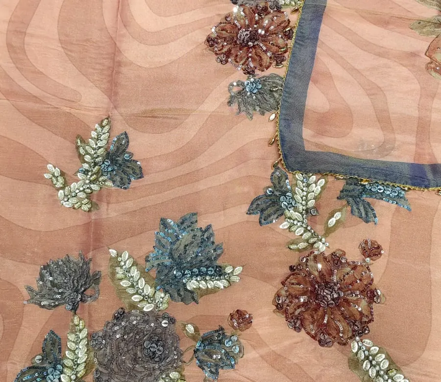 Beaded flowers in teal and copper on peach fabric