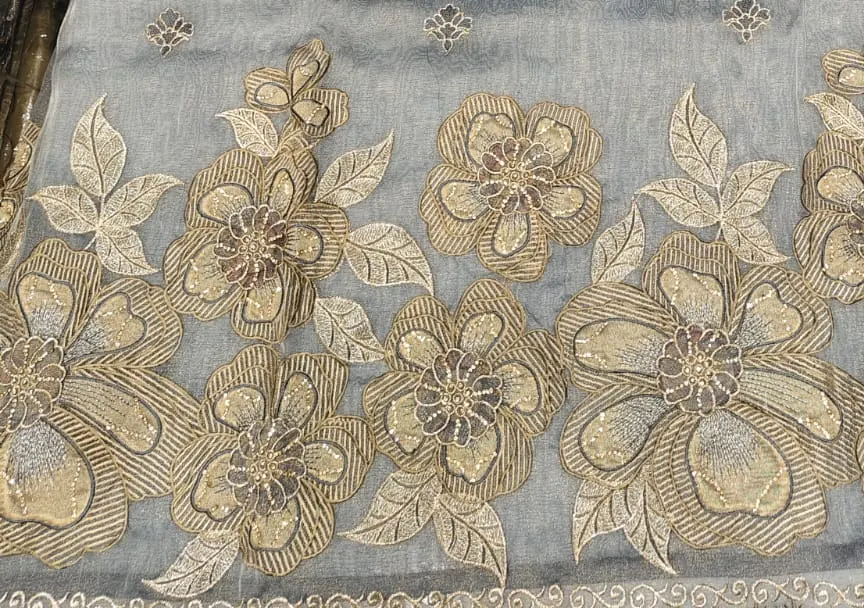 Gold thread floral border on dove grey fabric